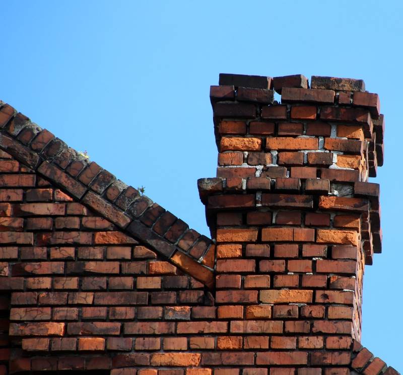 Damaged chimney on an White Marsh home showing cracks and missing mortar
